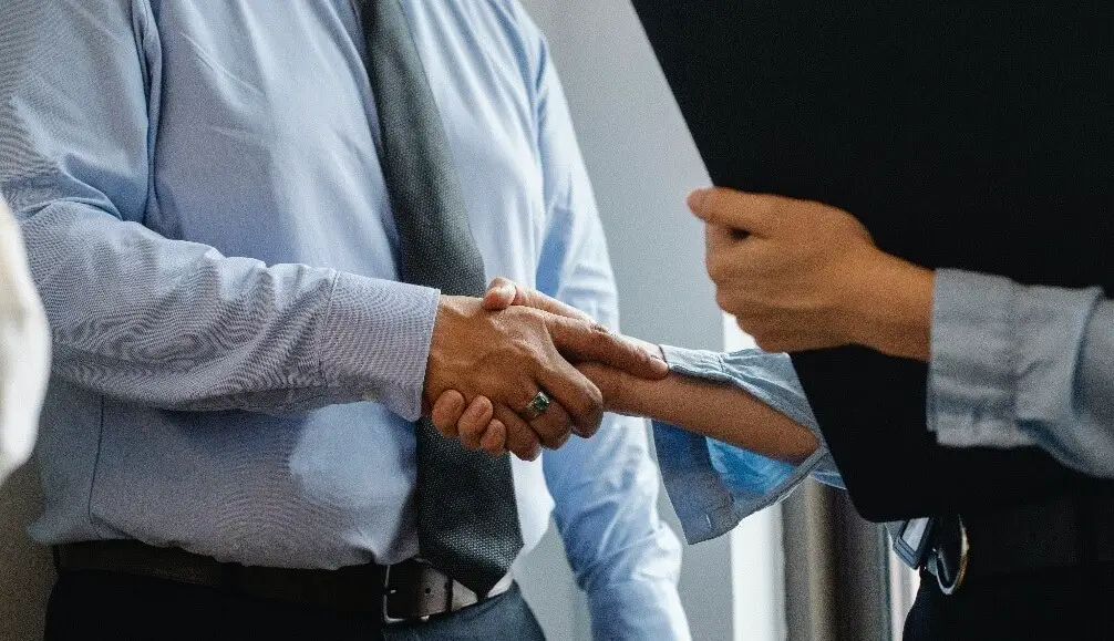 boss shaking hands with coworker
